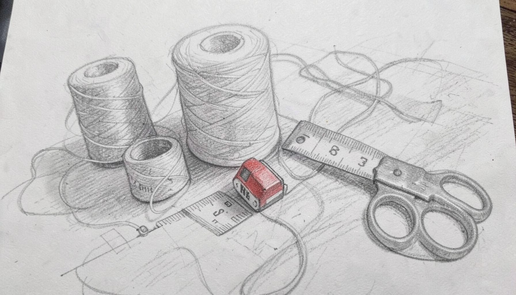 Graphite pencil sketch of spools of thread, a tape measure, and scissors arranged on a worktable, soft gray tones